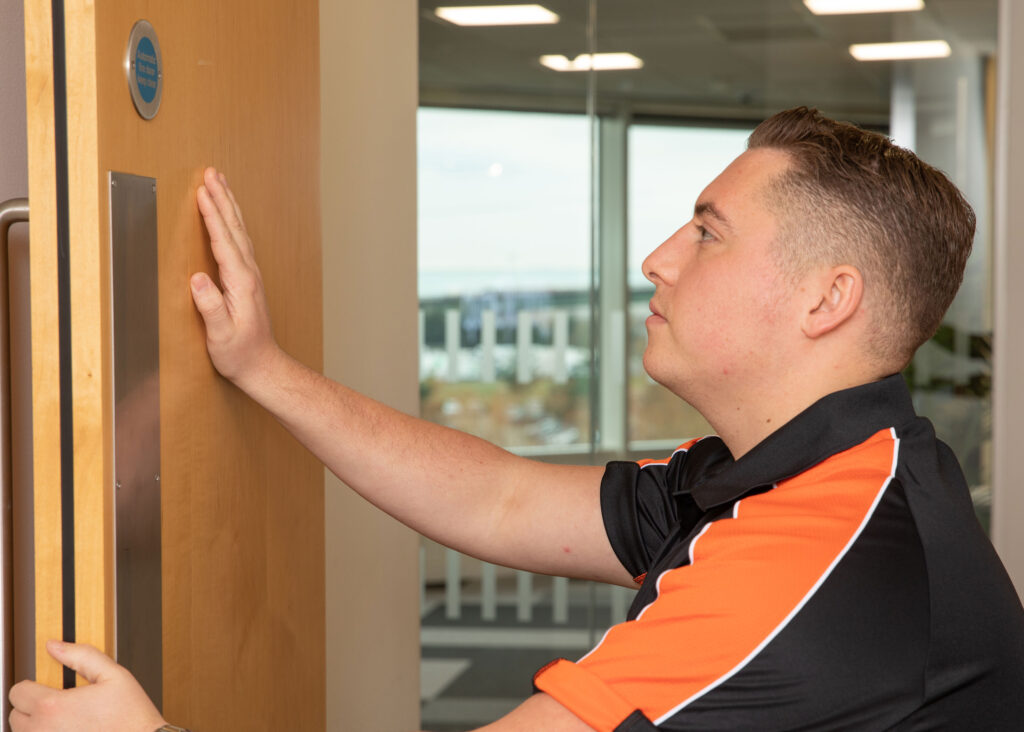 Global FM surveying a fire door