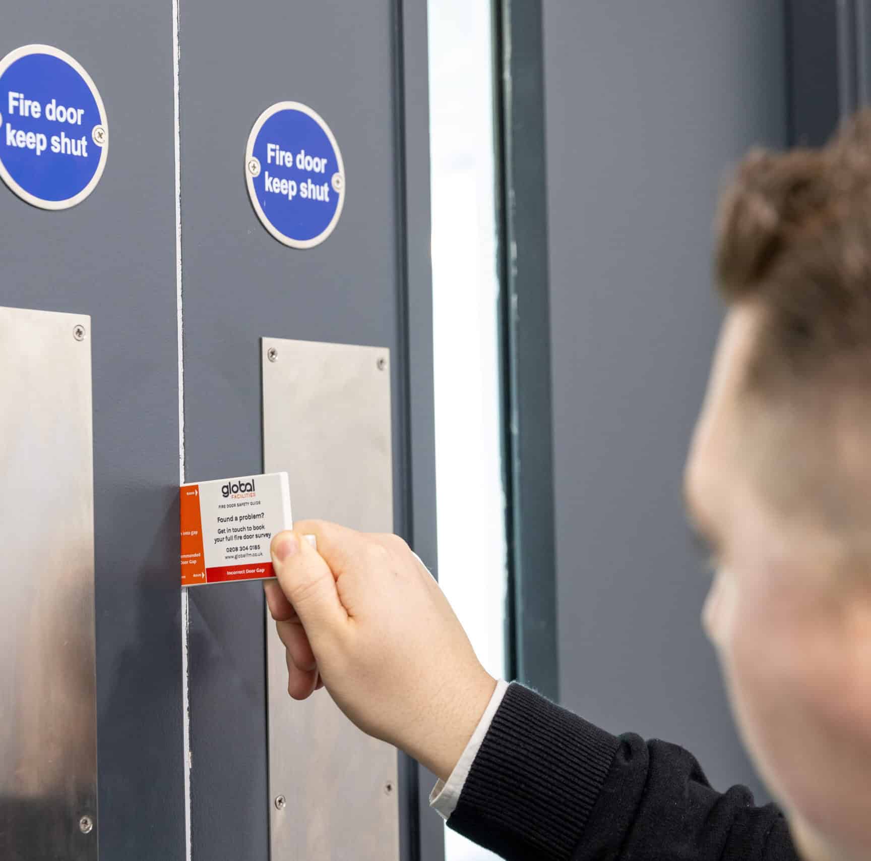Global Facilities Fire Door Inspector carrying out a fire door gap inspection.