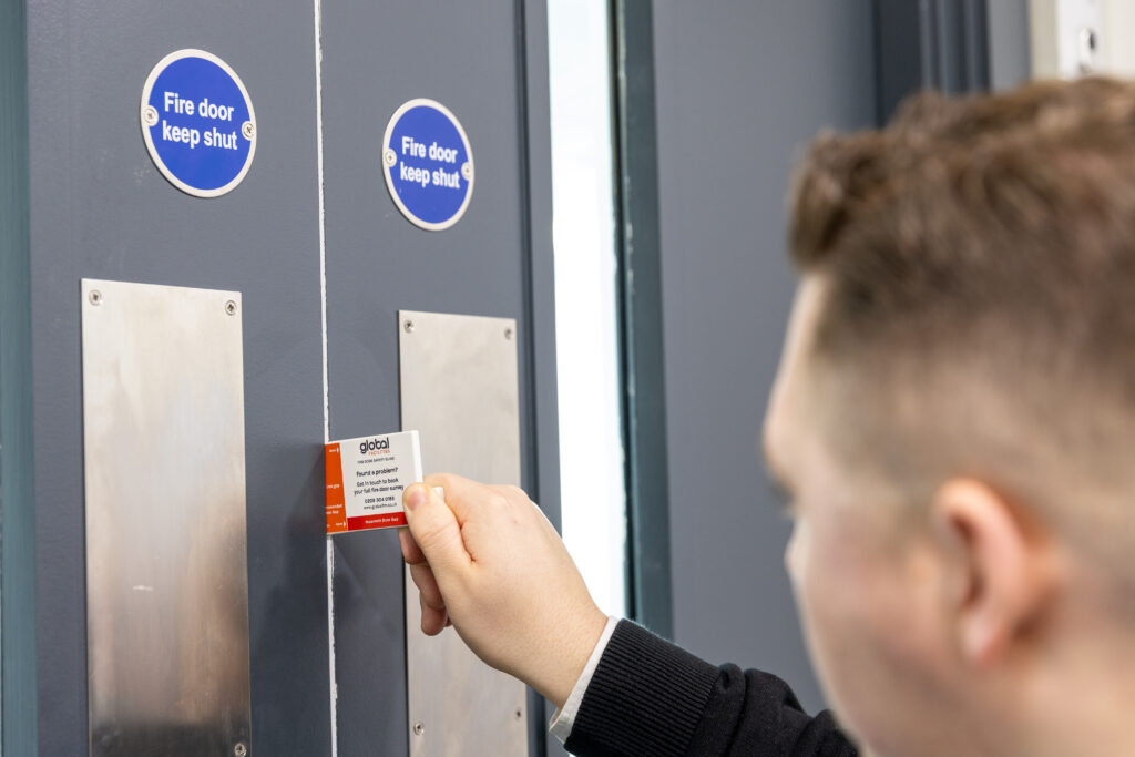 Global Facilities Fire Door Inspector carrying out a fire door gap inspection.