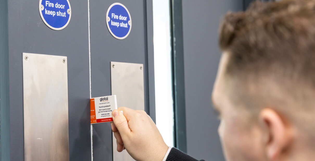 Global Facilities Fire Door Inspector carrying out a fire door gap inspection.